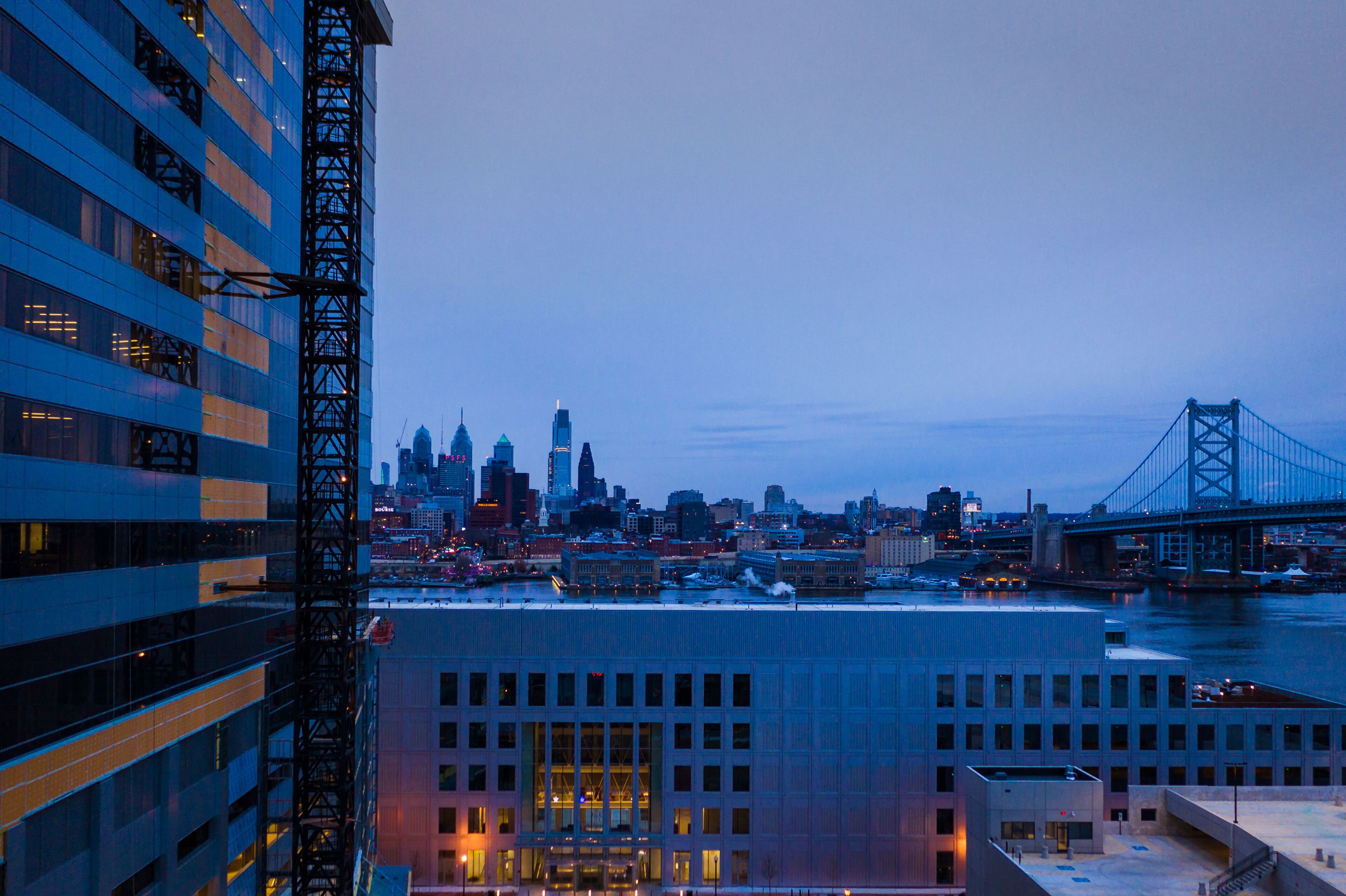 A city skyline with a prominent bridge and skyscrapers.