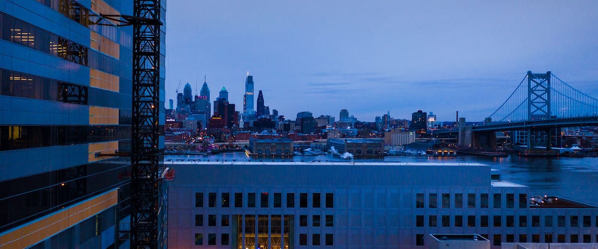 A city skyline with a prominent bridge and skyscrapers.