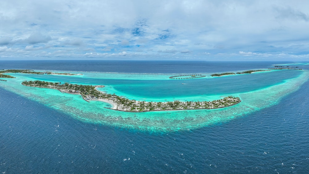 Panoramic aerial view of Fari Island surrounded by the Indian Ocean, Maldives archipelagos.