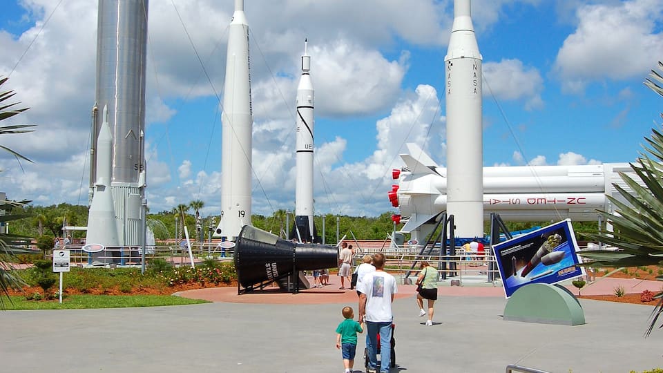 A space center with several rockets on display.