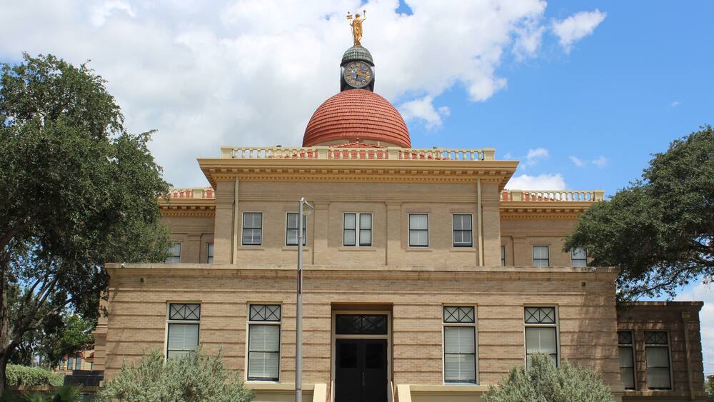 A building with a red dome and a clock tower.