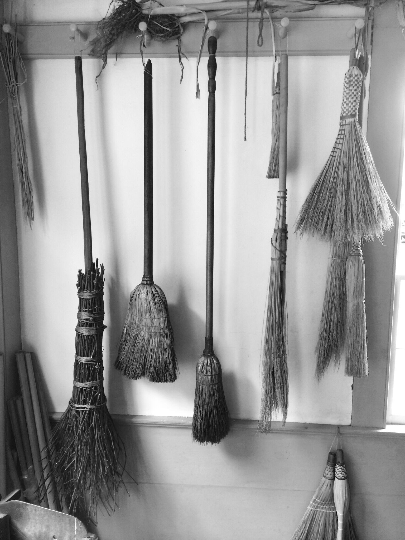 Handmade brooms on display in the museum's village