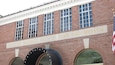 A brick building with a sign reading "National Baseball Hall of Fame and Museum".
