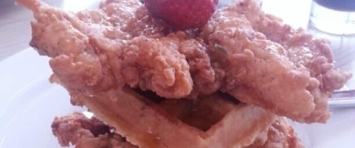 Chicken and waffles at the art museum. It is the best chicken and waffles I have ever had. It is waffles and chicken covered in a jalape?o maple syrup, all topped with a strawberry.