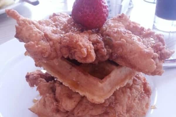 Chicken and waffles at the art museum. It is the best chicken and waffles I have ever had. It is waffles and chicken covered in a jalape?o maple syrup, all topped with a strawberry.