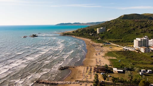 View to sandy beach of Adriatic Sea and to the city of Durres, Albania during sunset.