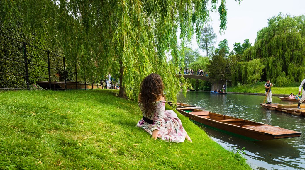 Girl sitting along River Cam near Kings College in the city of Cambridge, United Kingdom