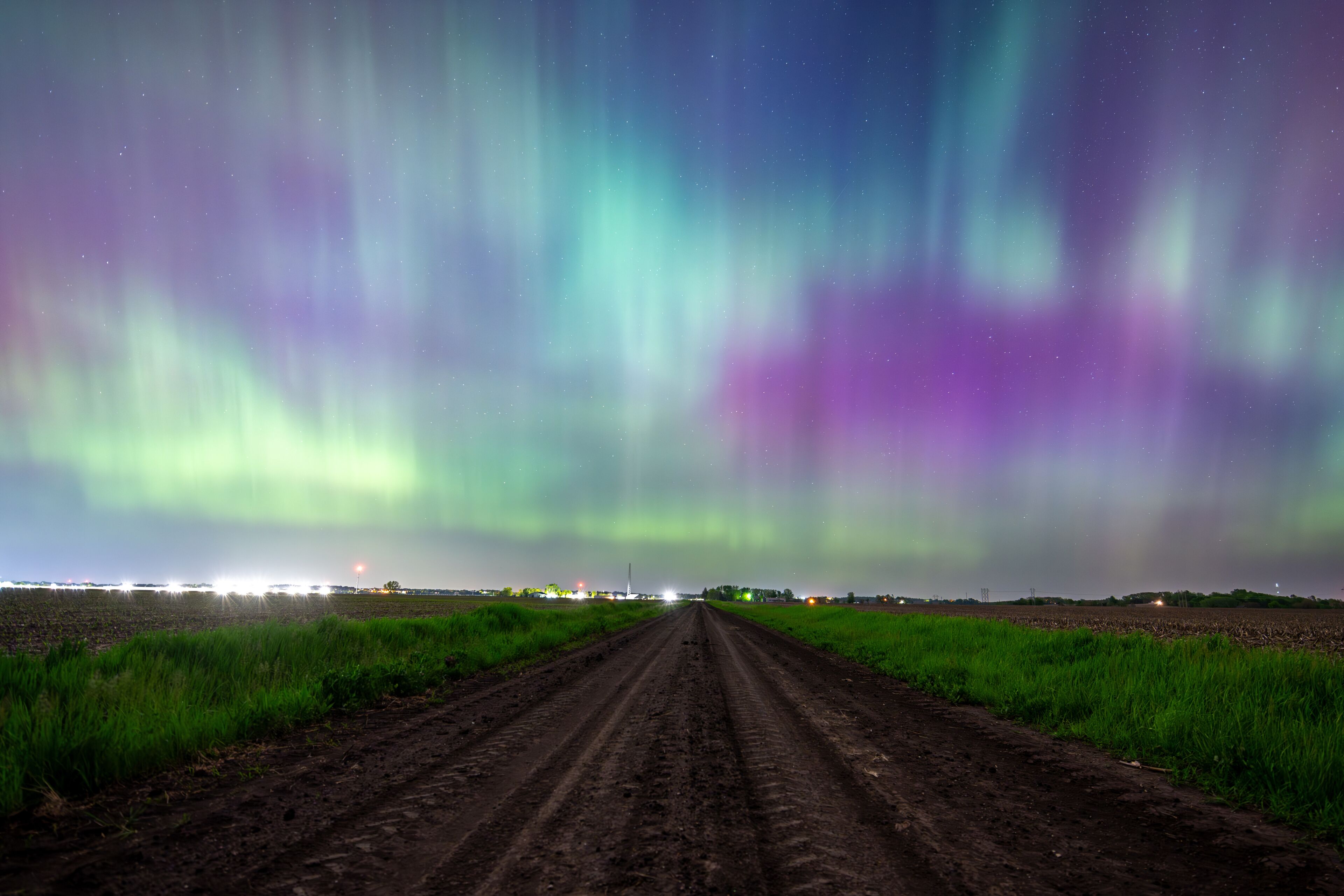 Northern Lights Storm on May 11th 2024 from Iowa City, Iowa, USA over a dirt road between two farm fields. 5.11.24