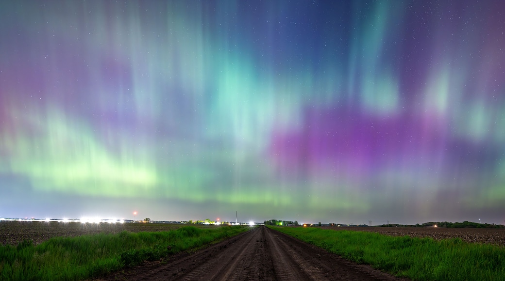 Northern Lights Storm on May 11th 2024 from Iowa City, Iowa, USA over a dirt road between two farm fields. 5.11.24