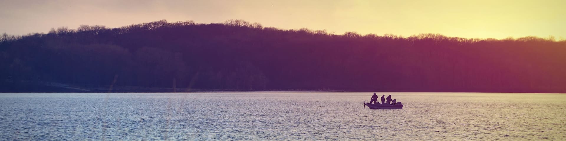 Fishermen on a boat at Lake McBride after sunset