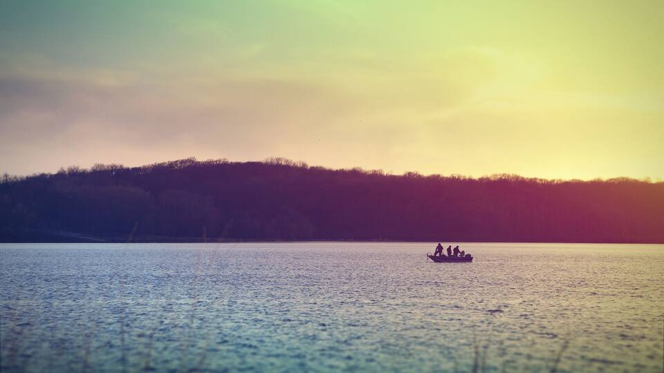Fishermen on a boat at Lake McBride after sunset