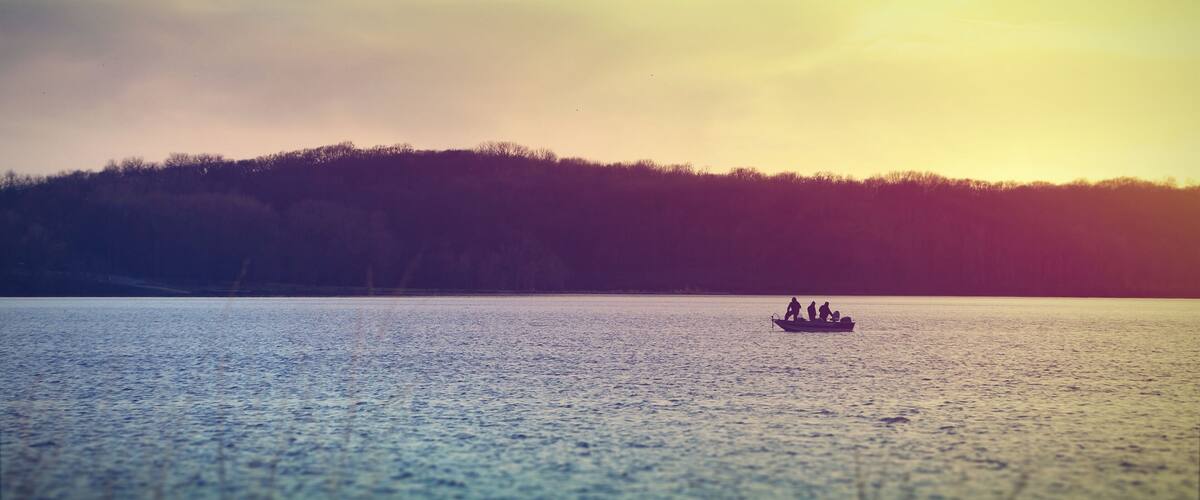 Fishermen on a boat at Lake McBride after sunset