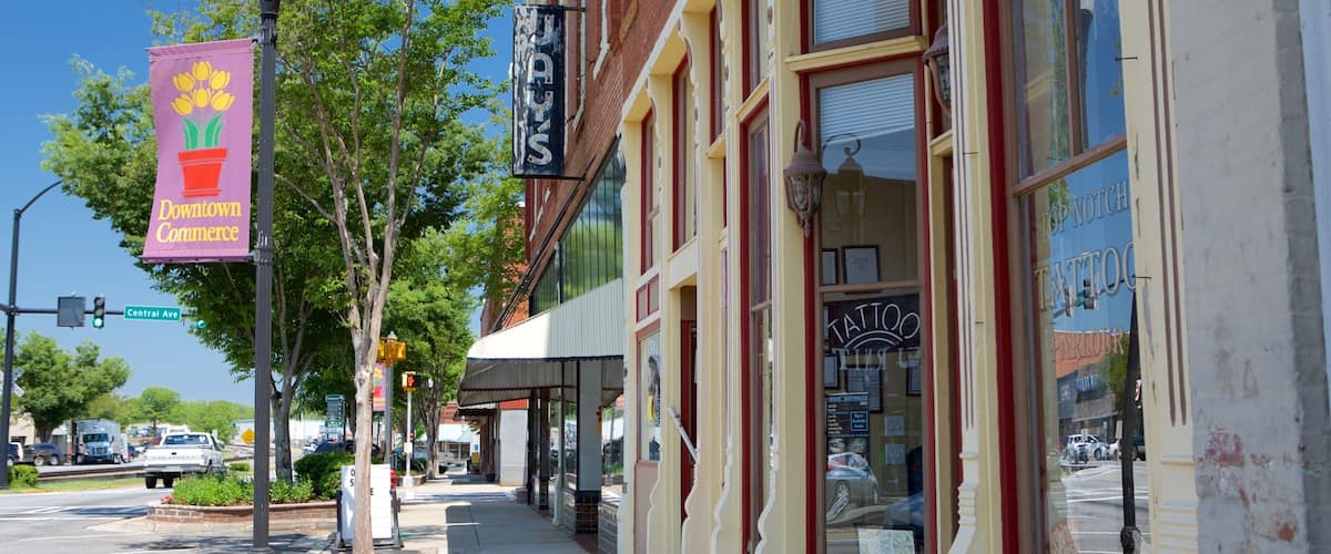 A street with storefronts, a 'Downtown Commerce' sign, and a 'Tattoo' shop.
