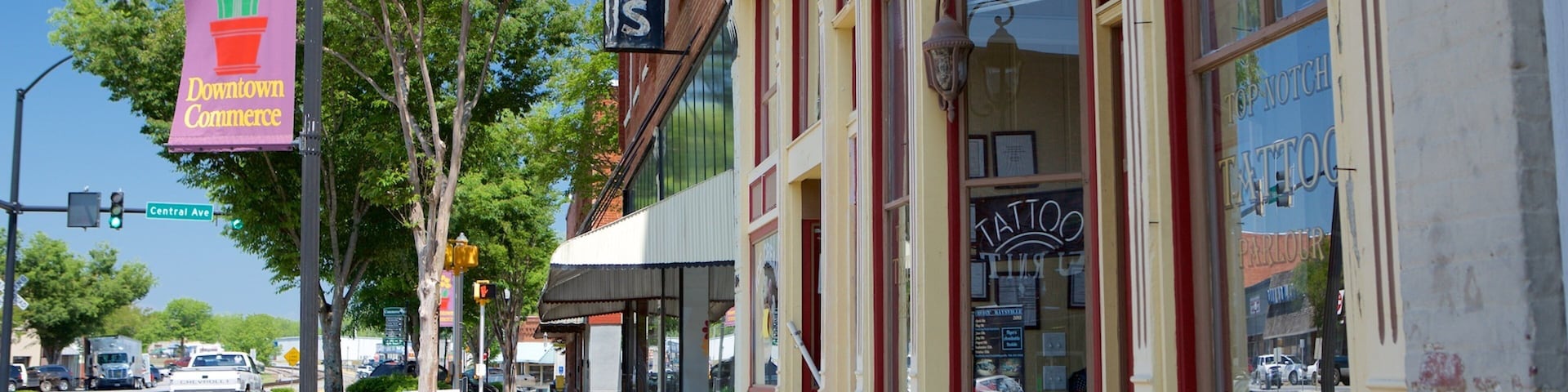 A street with storefronts, a 'Downtown Commerce' sign, and a 'Tattoo' shop.