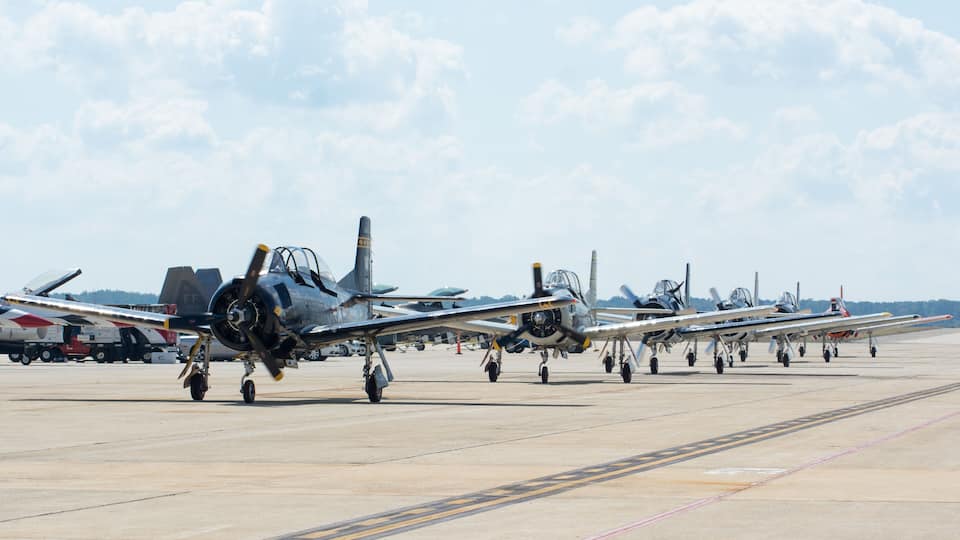 Vintage military aircraft parked on an airfield.