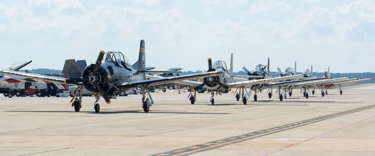 Vintage military aircraft parked on an airfield.