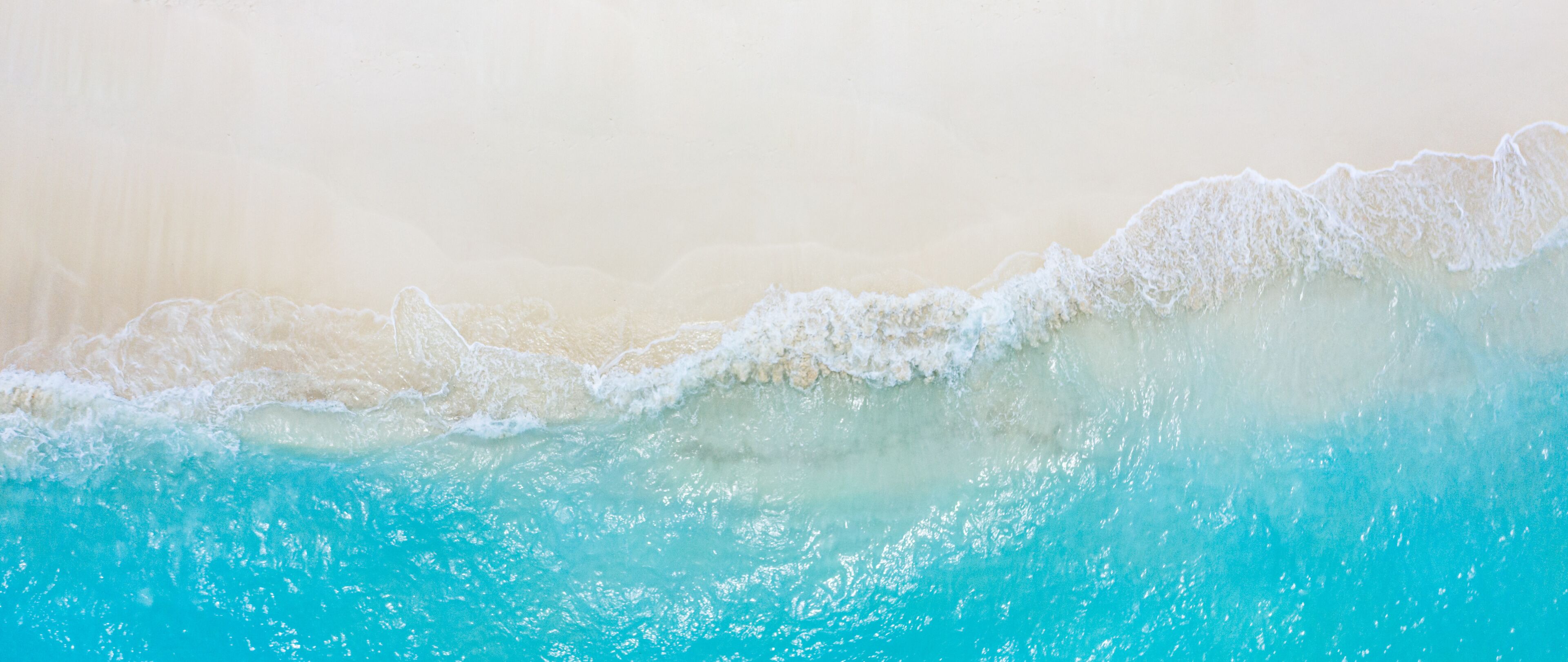 Relaxing aerial beach scene, summer vacation holiday template banner. Waves surf with amazing blue ocean lagoon, sea shore, coastline. Perfect aerial drone top view. Peaceful bright beach, seaside