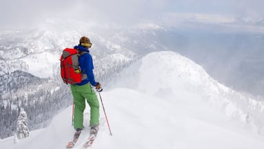 A backcountry skier at the top of a ridge near Columbia Falls, Montana.