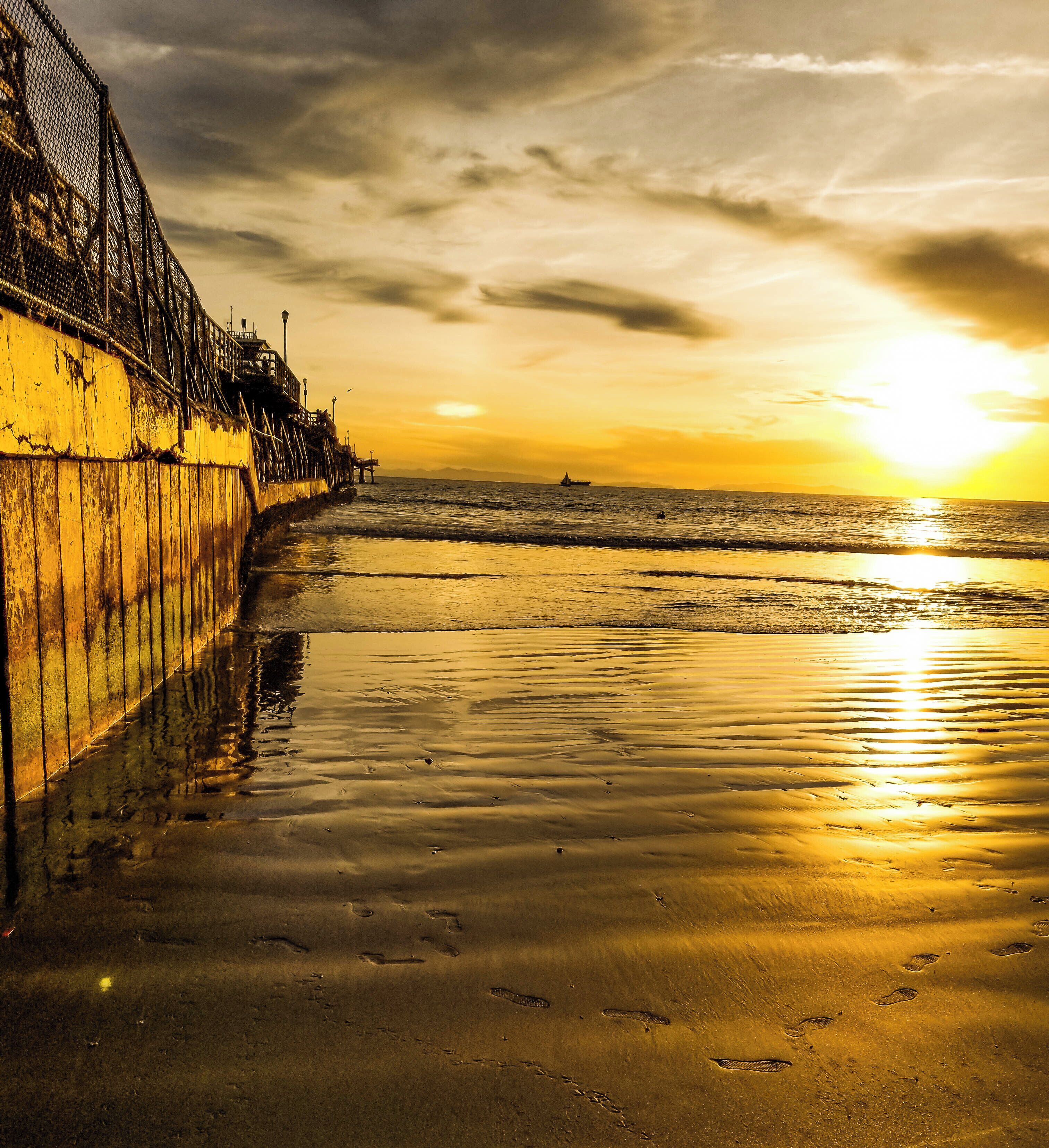 There's nothing like bare feet in the sand at sunset. This is a view down the side of the Seal Beach Pier in California. A great beach and very peaceful at sunset. #LifeAtExpedia #Nature