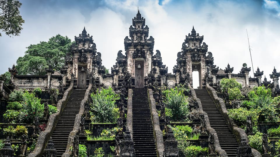 A temple with ornate architecture and a central staircase leading to a main entrance.