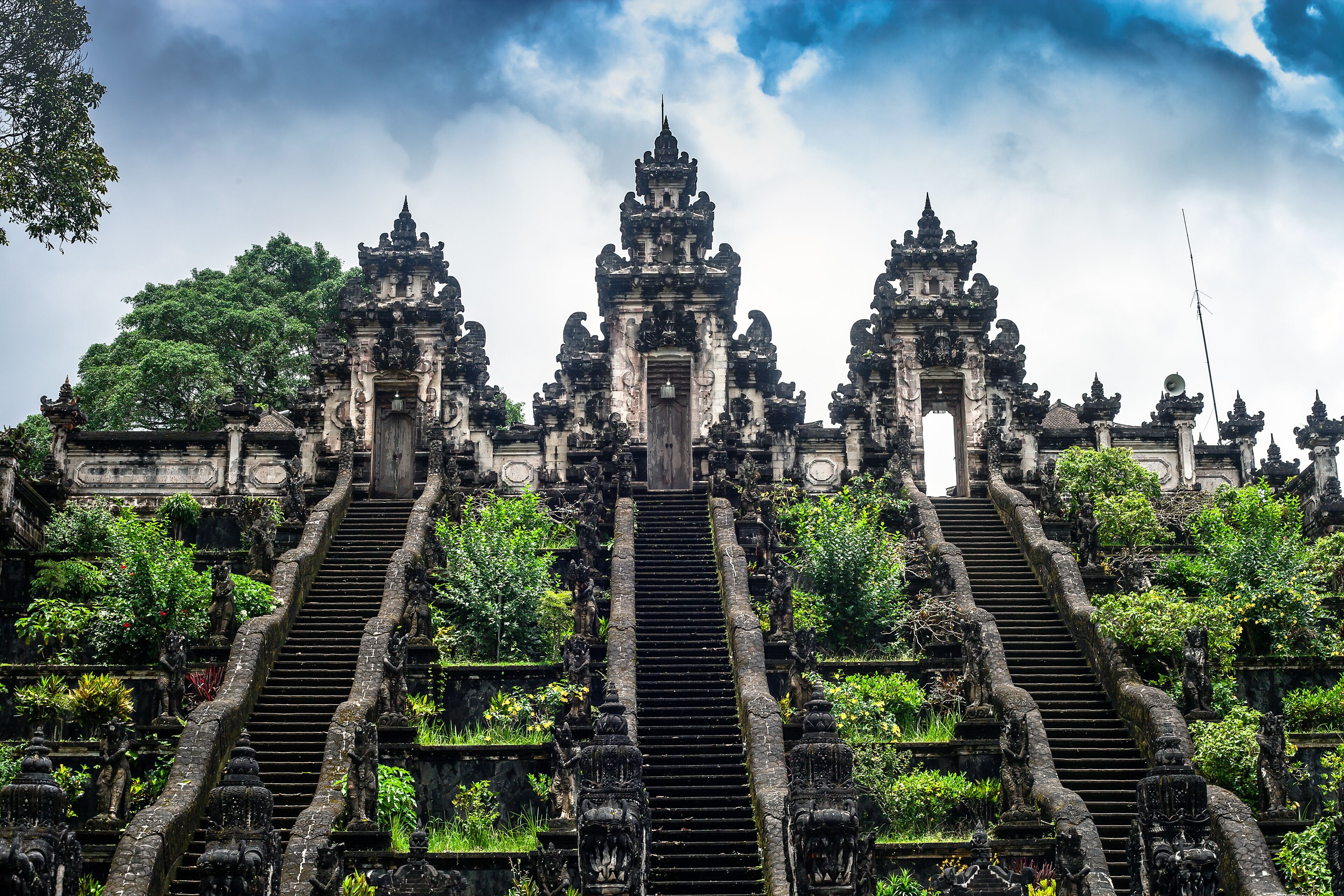 A temple with ornate architecture and a central staircase leading to a main entrance.