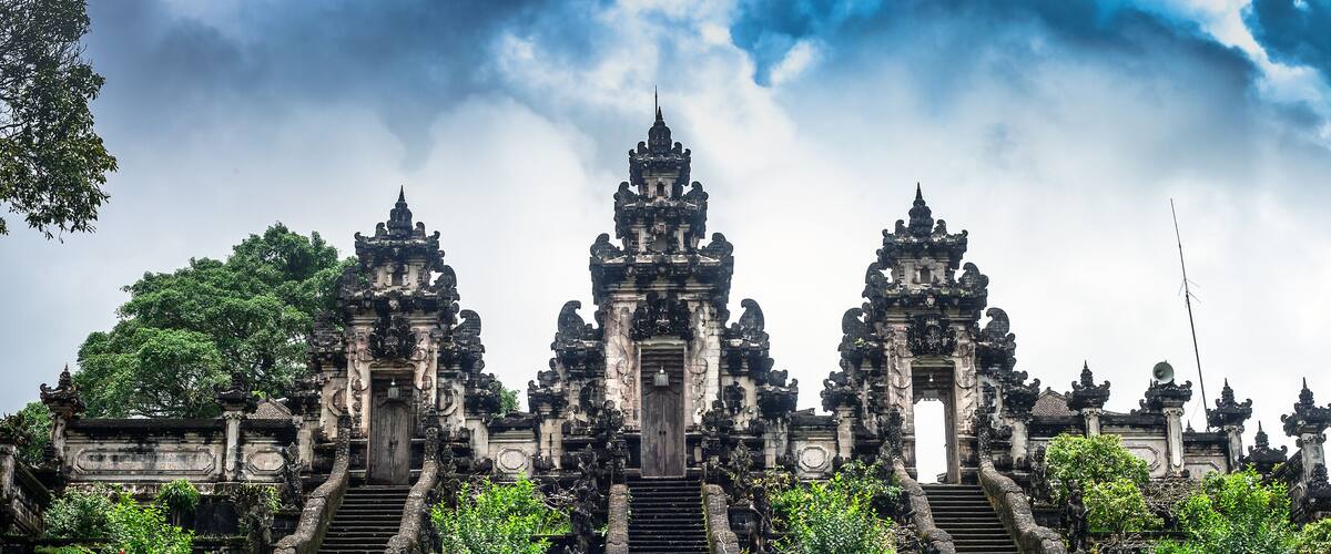 A temple with ornate architecture and a central staircase leading to a main entrance.