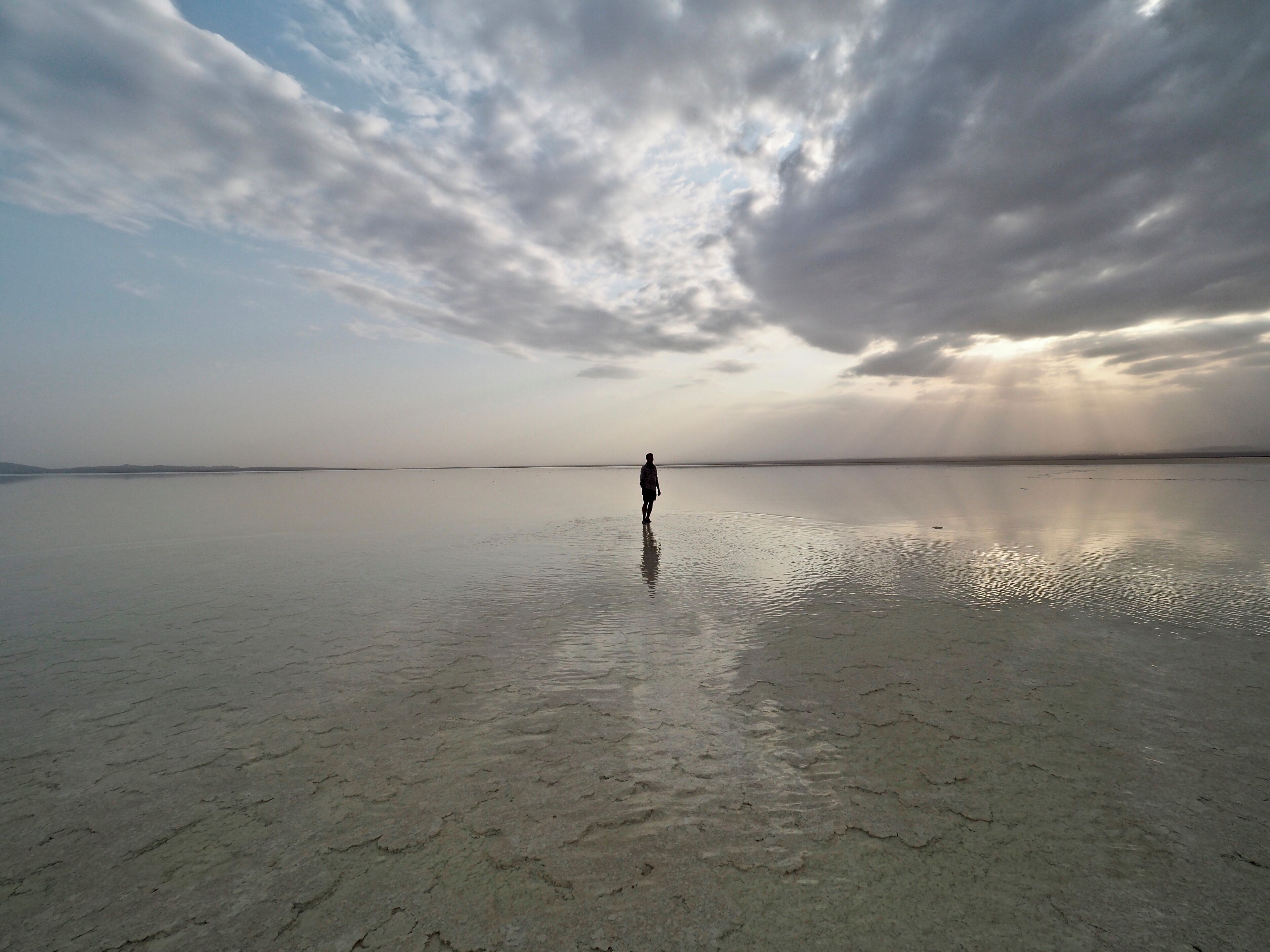 Evening at the salt lake Karum in Danakil Depression, Ethiopia with the same shallow water all around.