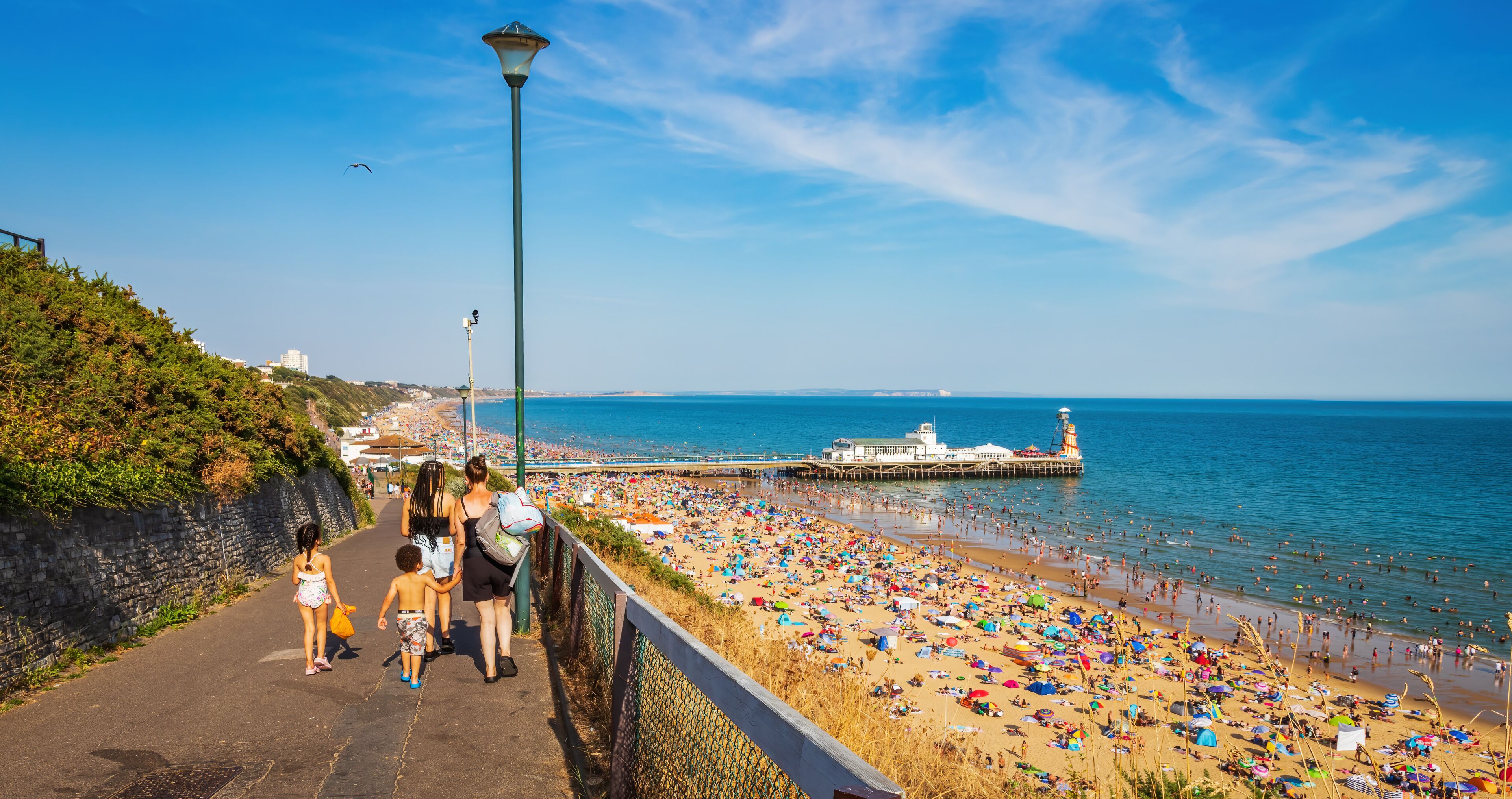 Woman with kids going towards Bournemouth Beach in Dorset ,England 