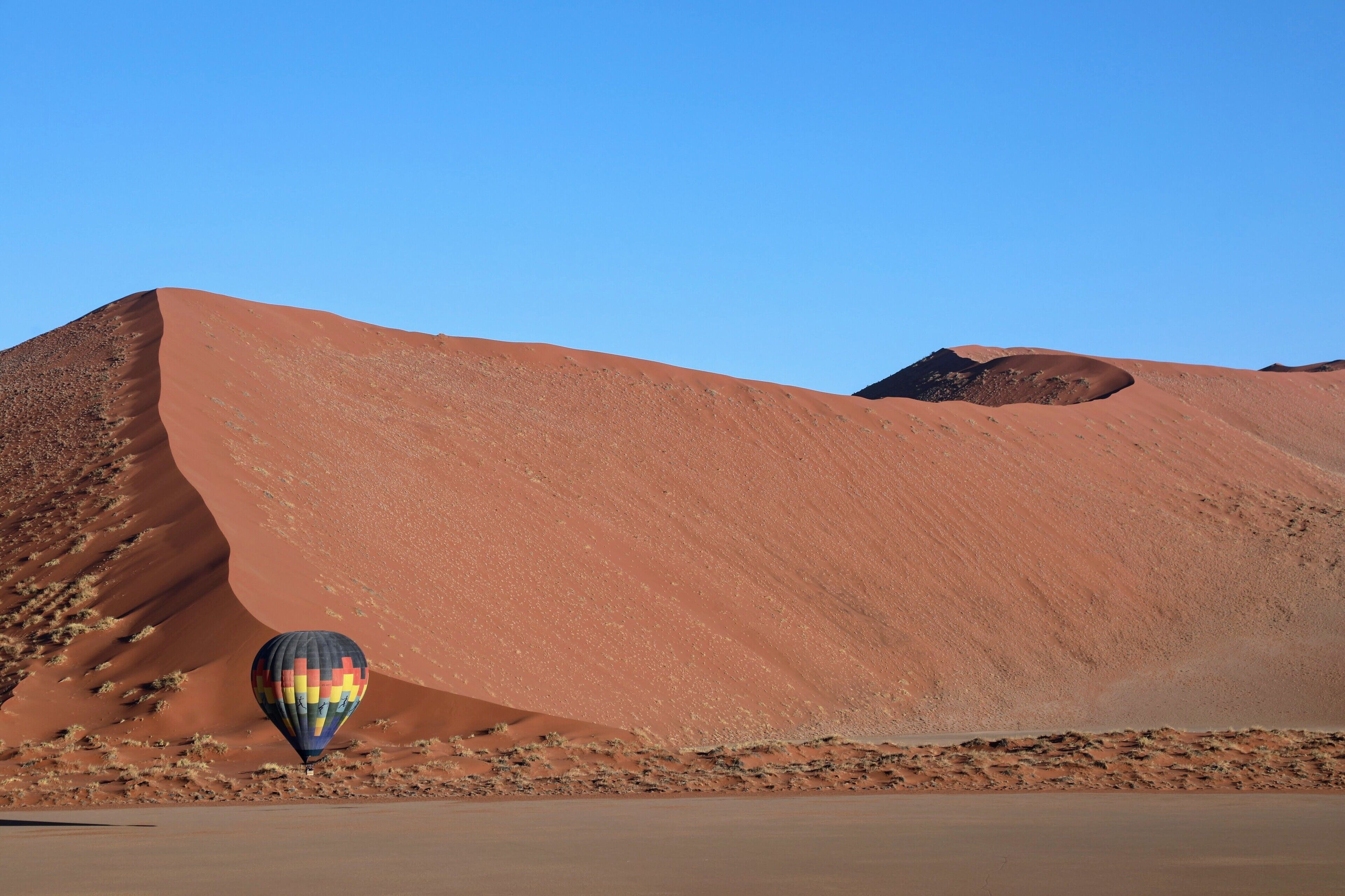 Floating gentle through the air above the great sand dunes of Sossusvlei in Namibia. This was my first ( and only so far) hot air balloon ride and it was just incredibly beautiful. The color of the dunes softens and lightens as the sun rises, but at this perfect moment they were fairly glowing a stark orange color as the bits of rusted iron in the sand shows through. Travel is an amazing thing, there are wonders in this world, not just far away but in this country, in this state, in this city and in your life if you take the time to look for them. 
Find the wonder in your life my friends, it is there in the land and the people around you.
http://balloon-safaris.com/ are the ones that took me up I believe