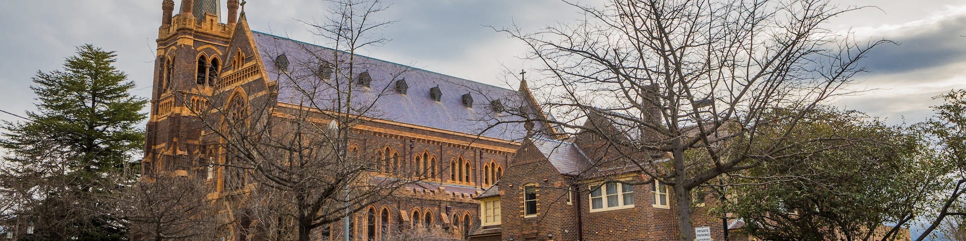 A historic church with a tall spire and brick architecture.