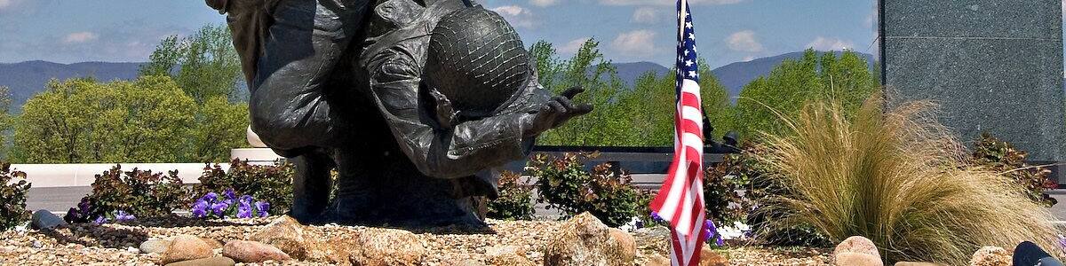 The National D-Day Memorial is an awe-inspiring tribute to the D-Day Invasion, the largest amphibious military landing the world has ever seen. Bedford, Virginia, was chosen as the location of the memorial because the community of Bedford suffered the highest per-capita D-Day losses in the nation.
The memorial is spread over 88 acres and is divided into patterns which represent the various stages or aspects of the invasion.
The centerpiece of the memorial is the Victory Plaza arch, which can be seen for miles. The arch contains a single word, Overlord, referring to Operation Overlord, the code name of the Battle of Normandy. The arch is crowned with five chiseled elements designed to resemble the roofs of houses seen by airborne troops as they passed over the Normandy countryside on the eve of D-Day. The chiseled elements are painted in a black and white pattern, just like the stripes painted on the wings of Allied aircraft.