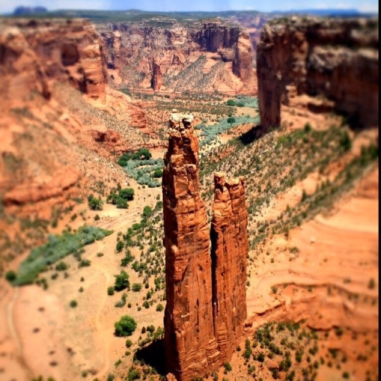 "The park's distinctive geologic feature, Spider Rock, is a sandstone spire that rises 800 feet (240 m) from the canyon floor at the junction of Canyon de Chelly and Monument Canyon. Spider Rock can be seen from South Rim Drive. According to traditional Navajo beliefs the taller of the two spires is the home of Spider Grandmother." -wiki-