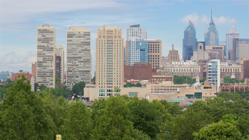 A city skyline with various high-rise buildings, including a Hilton hotel.