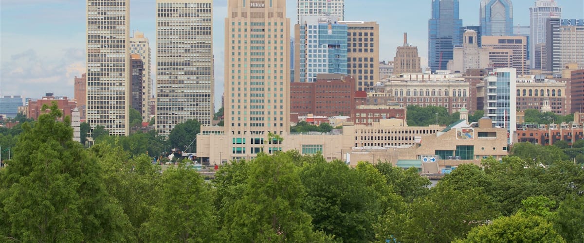 A city skyline with various high-rise buildings, including a Hilton hotel.