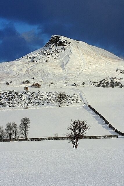 A snow-covered mountain with a clear sky.
