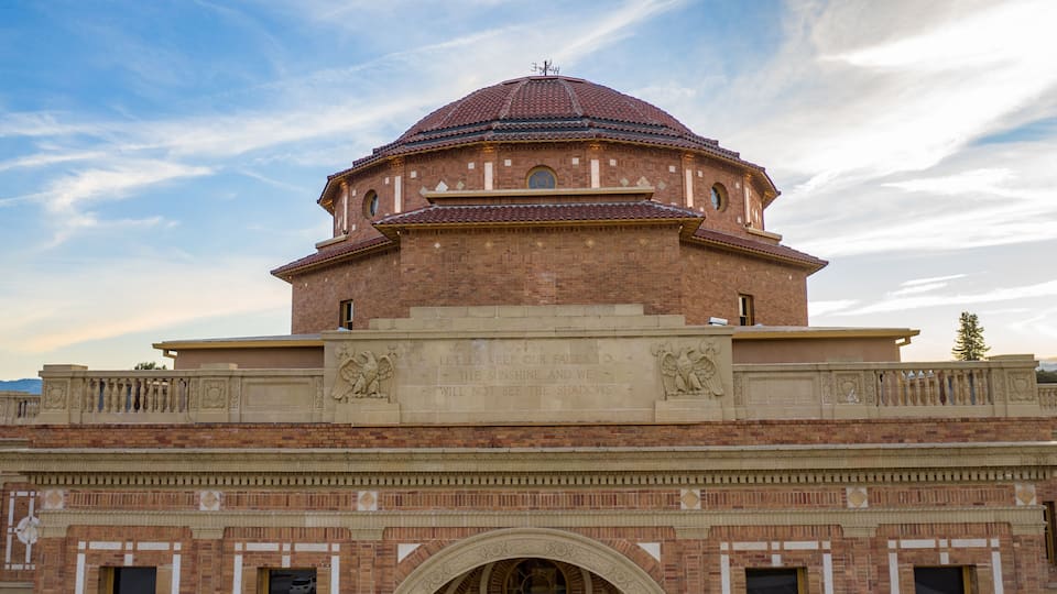A large brick building with a dome and an arched entrance.