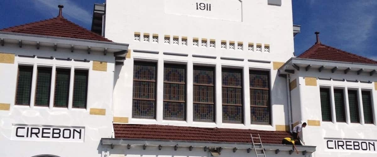 A white building with the year 1911 and the name 'CIREBON' on its facade.
