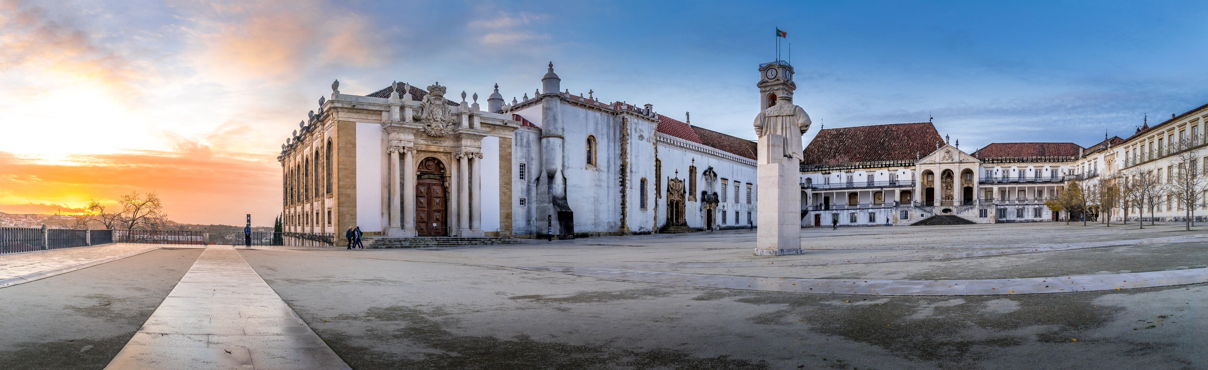 Sunset panorama of the Biblioteca Joanina world famous Baroque university library in Coimbra Portugal, clock tower and royal palace and Chapel