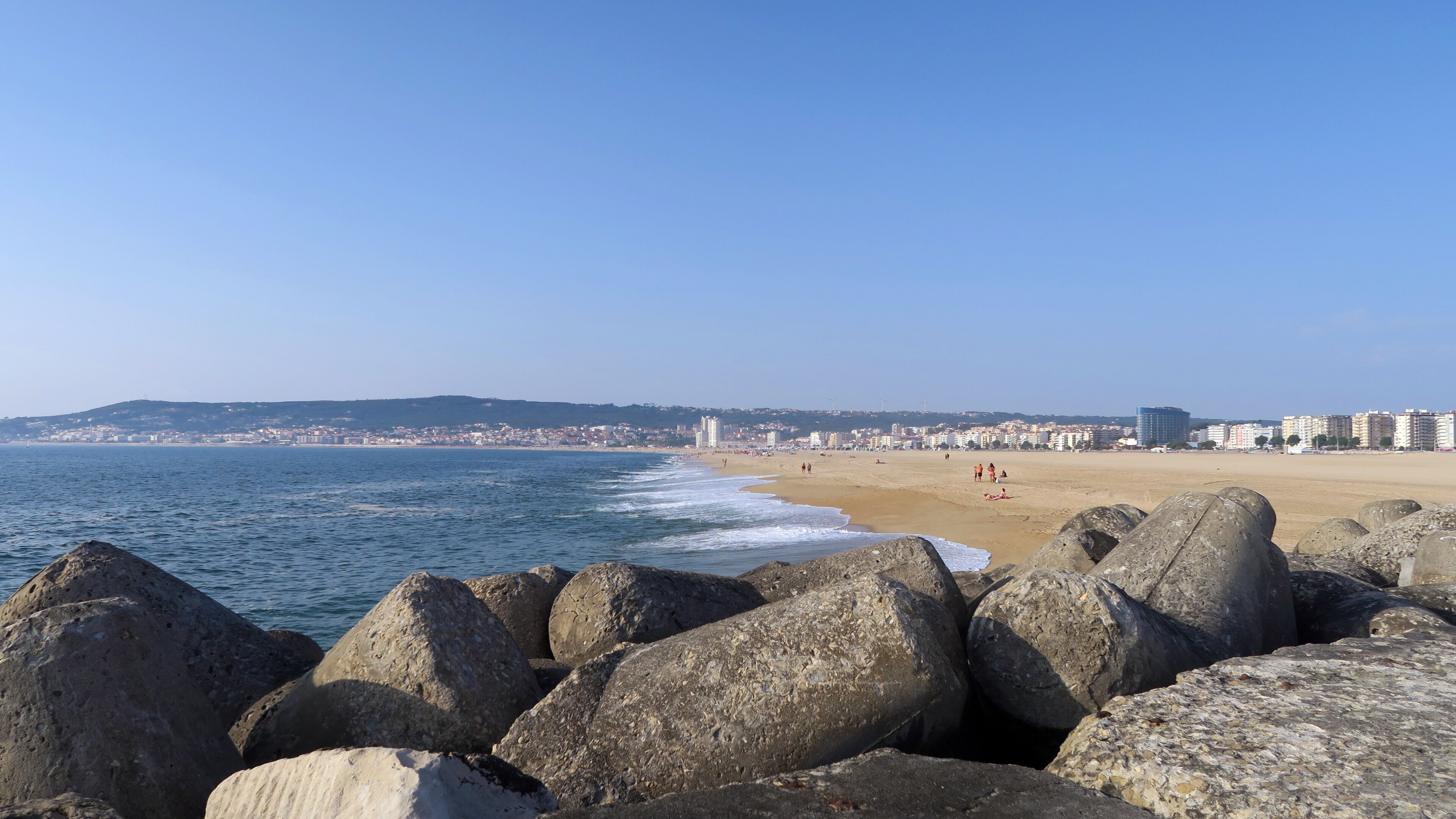 Figueira da Foz is a city and a municipality in the Coimbra District, in Portugal. People fishing on a sunny day.