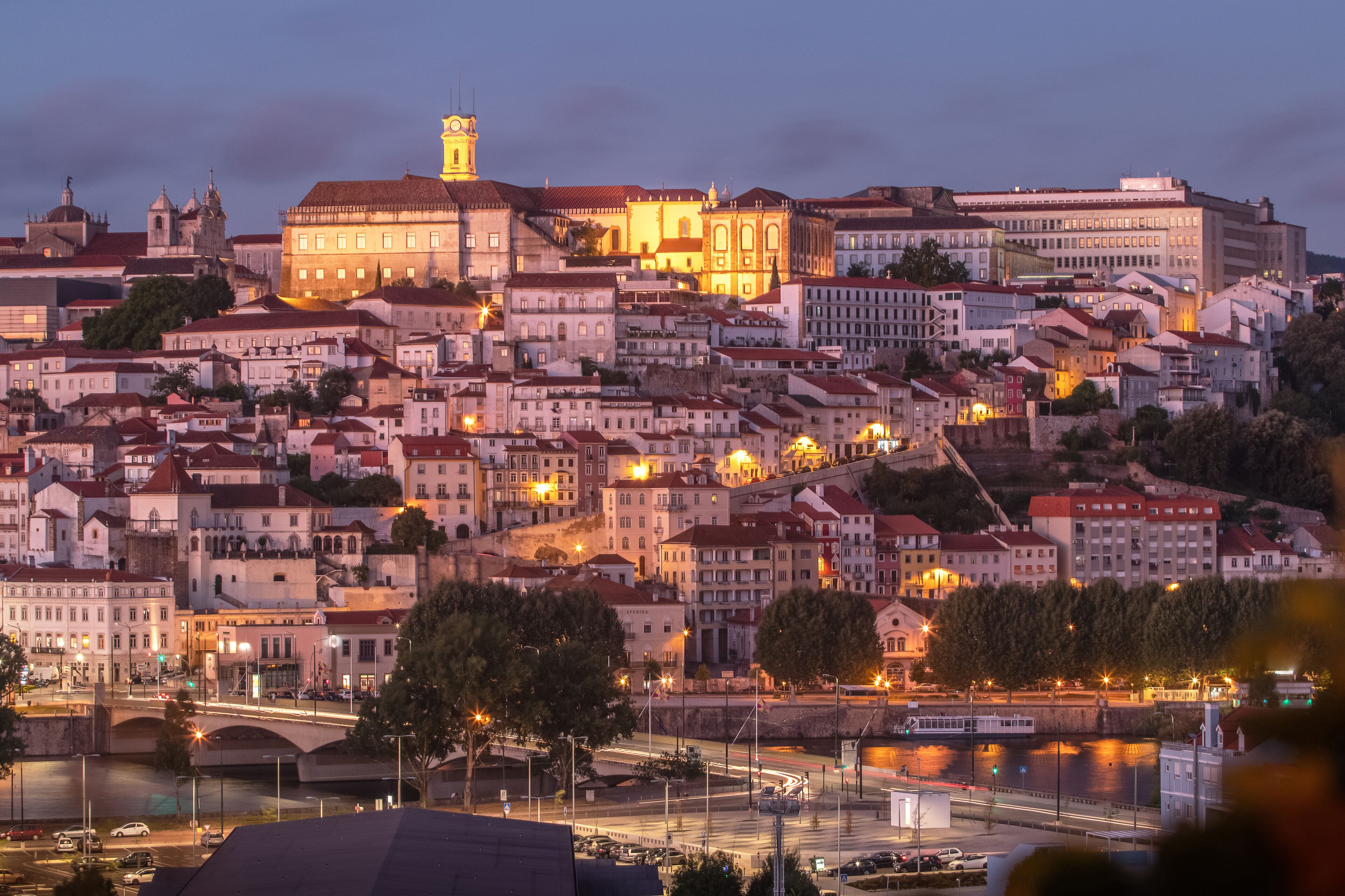 Coimbra old town with University of Coimbra, seen from Santa Clara, with the Mondego river and Santa Clara bridge on foreground