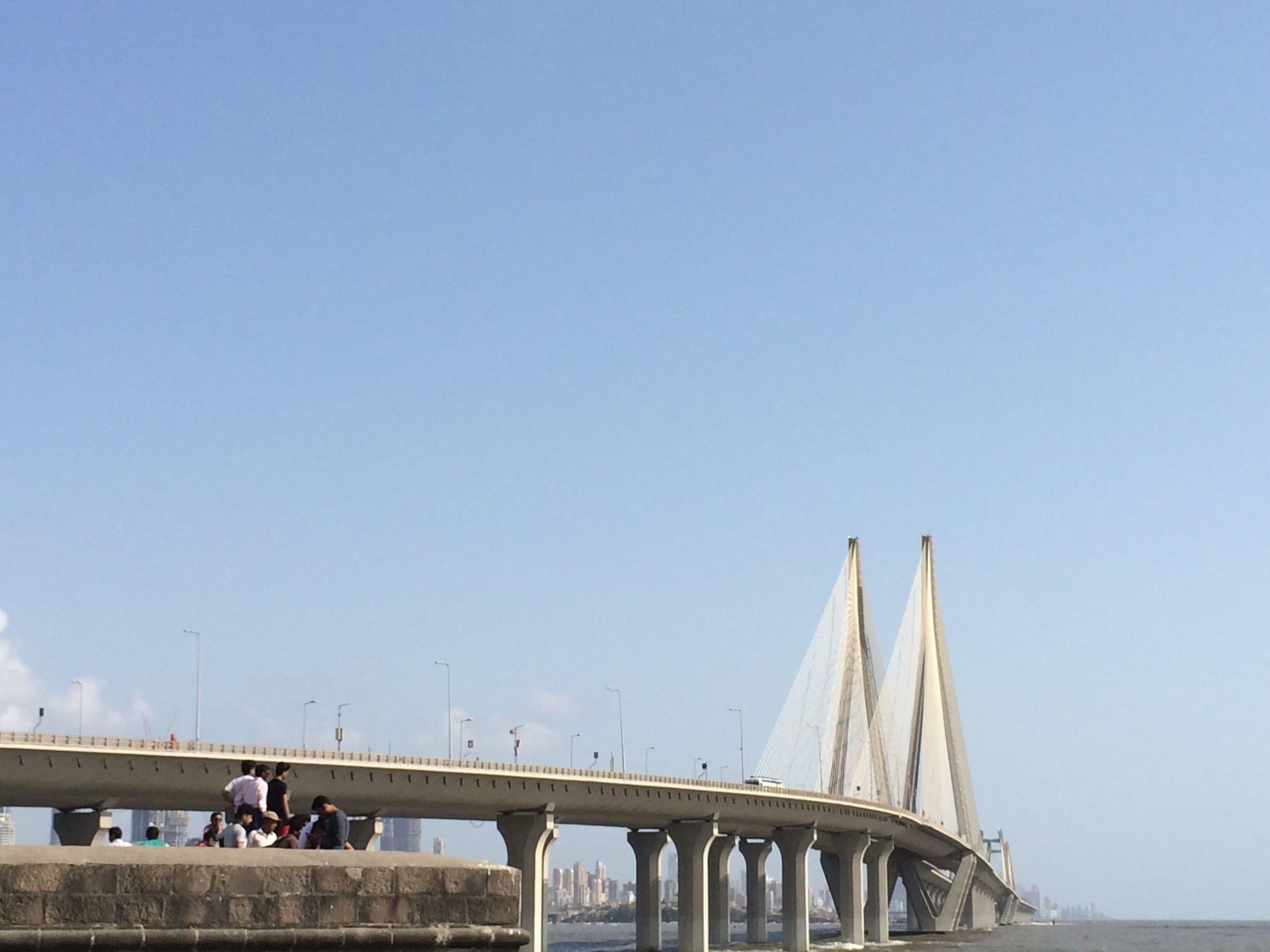 A modern cable-stayed bridge with multiple towers and a pedestrian walkway.