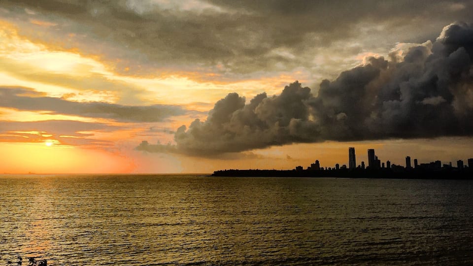 Calm over the water. Stormy and chaotic over the city. This is Mumbai.