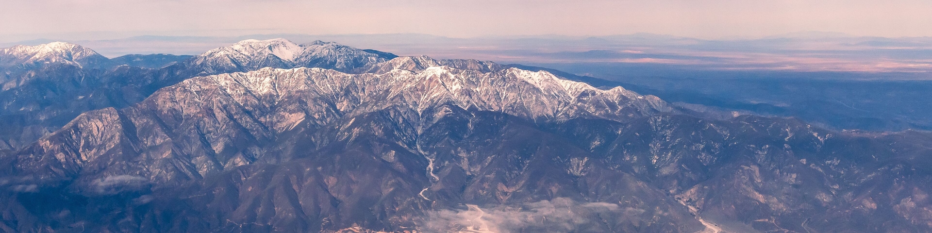 Aerial view of the San Gabriel Mountains outside of Los Angeles featuring Mt Baldy and Mt San Antonio's