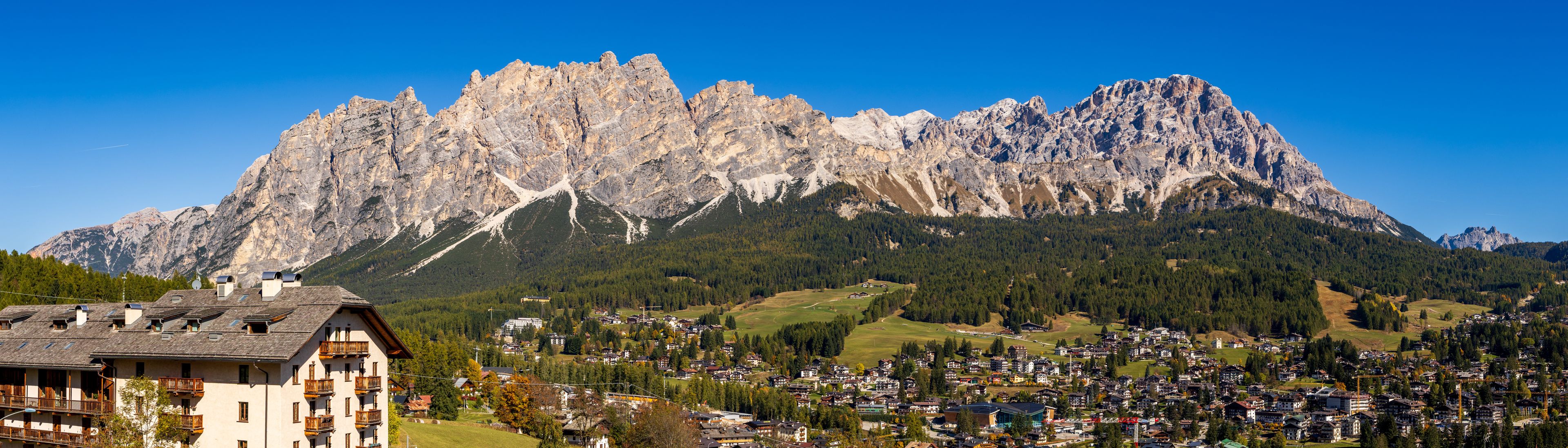 Cortina d'Ampezzo in the afternoon sun - view and rock ridge above the city