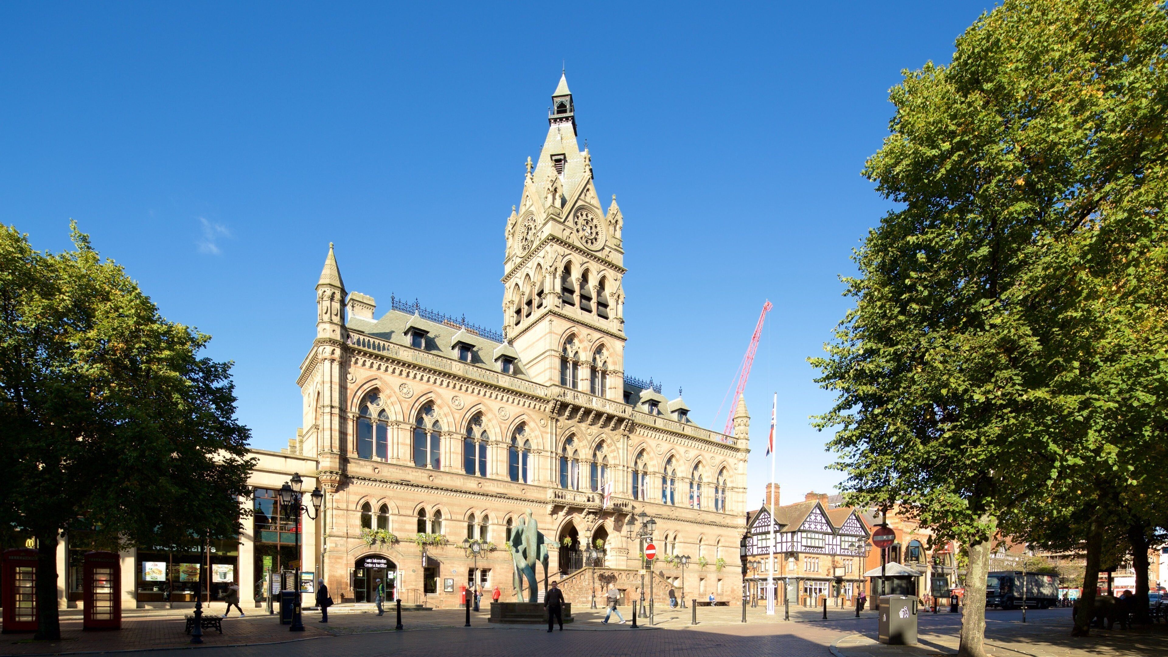 A historic building with a tall tower and arched windows.
