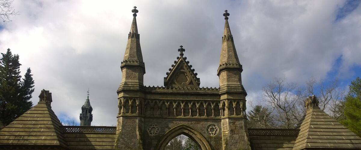 The impressive front main gate of Forest Hills Cemetery standing out against the #blue sky.
Built in 1848, Forest Hills Cemetery is a historic 275-acre cemetery, greenspace, arboretum and sculpture garden located in the Jamaica Plain neighborhood of Boston.