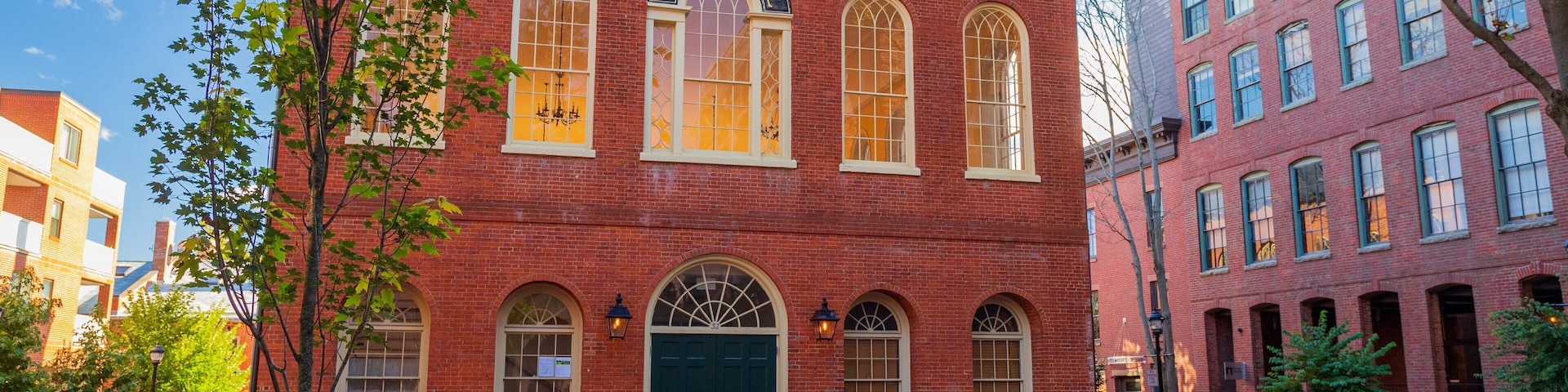 A red brick building with arched windows and a Town Hall sign.