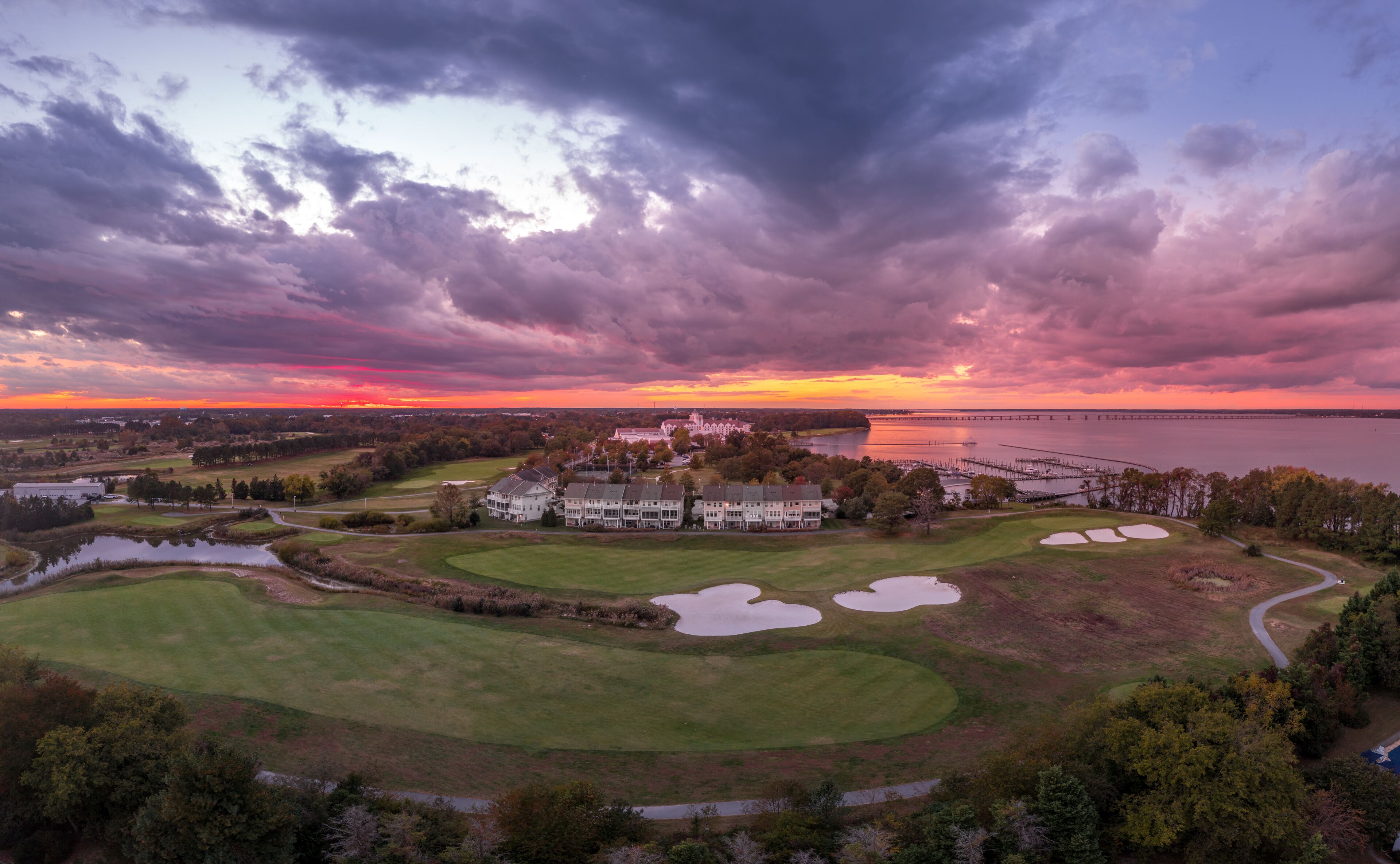 Aerial sunset view of a resort with a golf course near the Chesapeake in Cambridge Maryland with dramatic sky