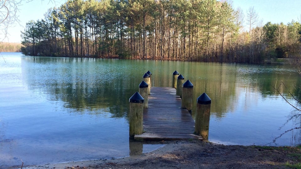 1.5 miles around. No swimming. But a playground for the kiddos, dog friendly and tons of fishing spots :)