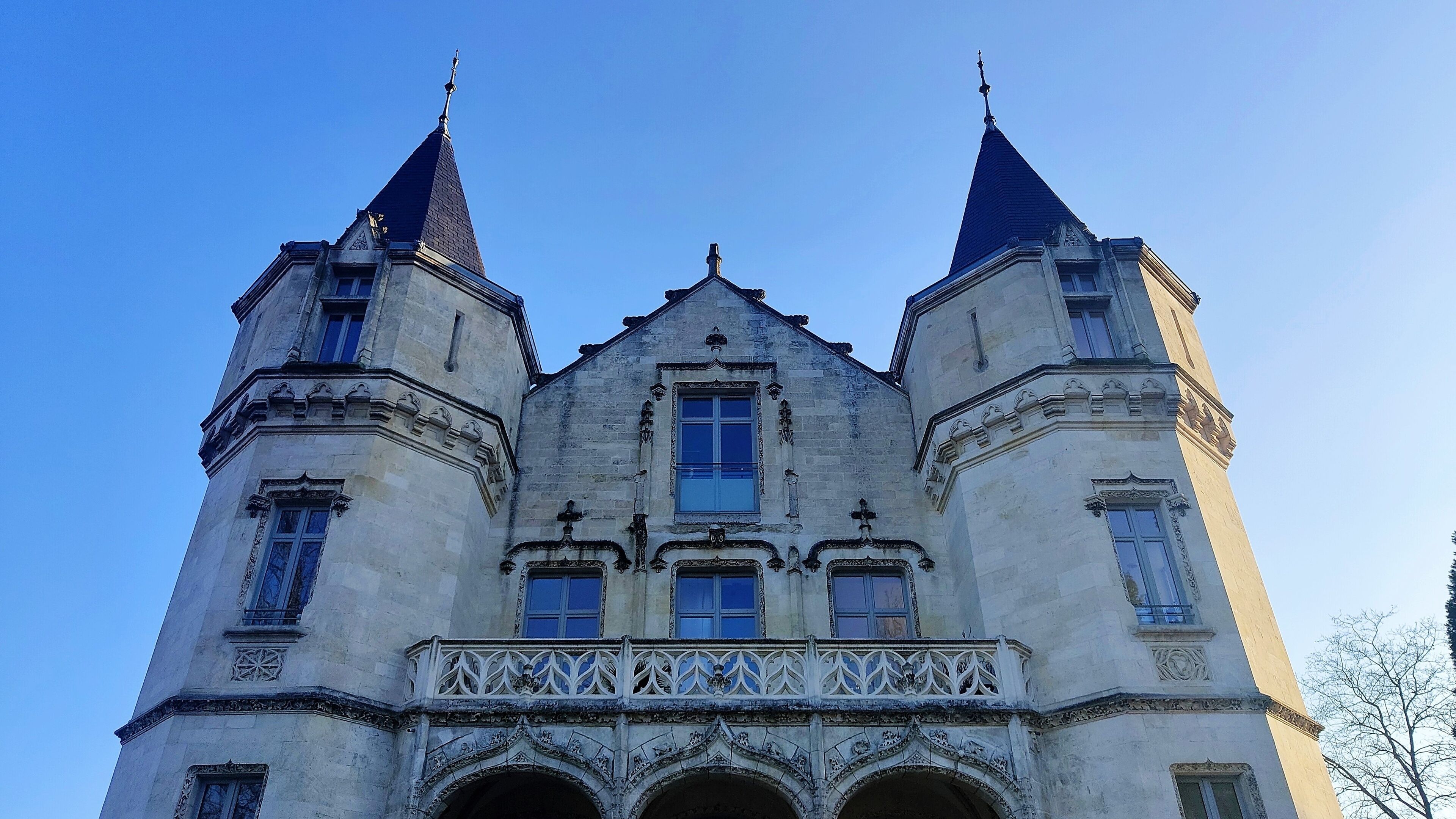 A historic building with two prominent towers and a central entrance.